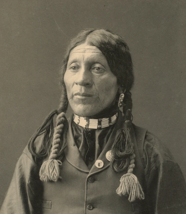a native american woman with ids and a necklace