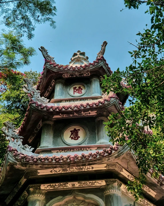 the top of the pagoda is decorated with flowers and vines