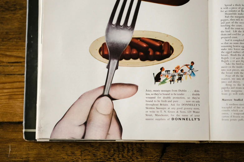 an open book with a fork on a plate