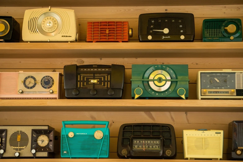 different vintage radio in a row on shelves