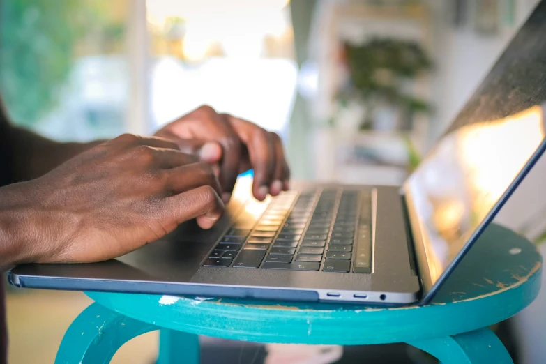 a person typing on a laptop computer