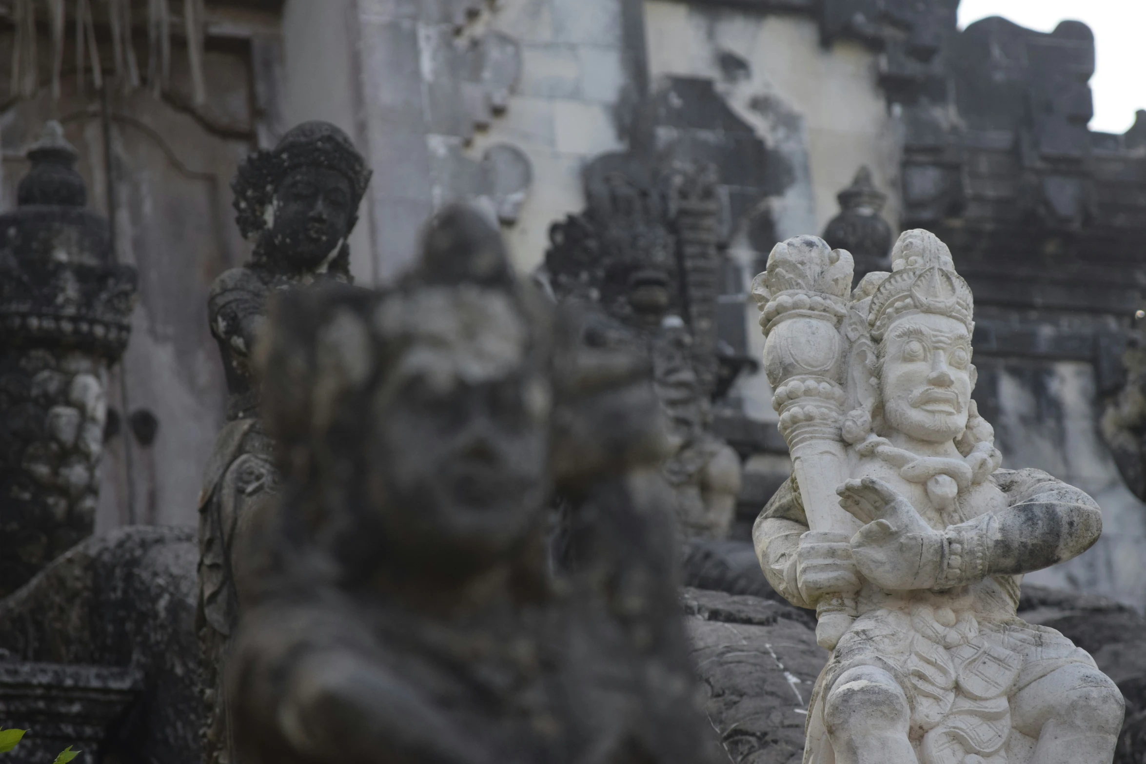 some statues that are on the side of the building