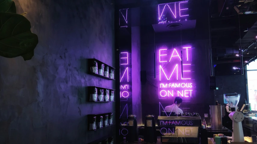 there are purple neon signs that hang from the ceiling