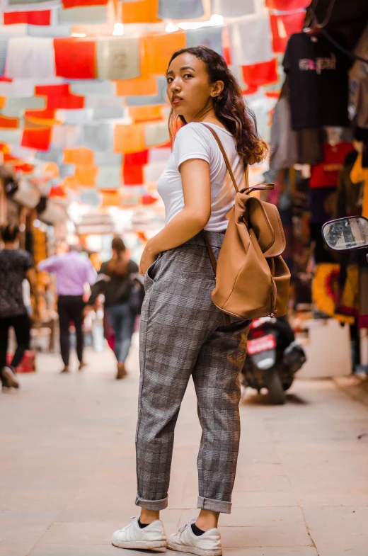 a girl is standing in a narrow area