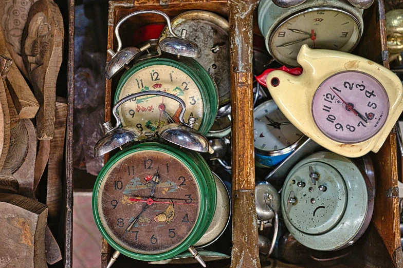 several different types of clocks are arranged in a box