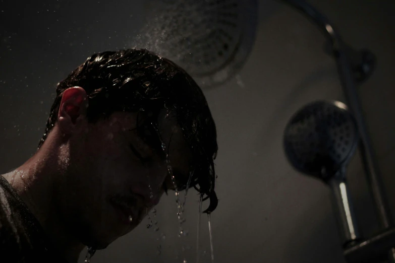 a man taking a shower with no showerhead and rain pouring on his face