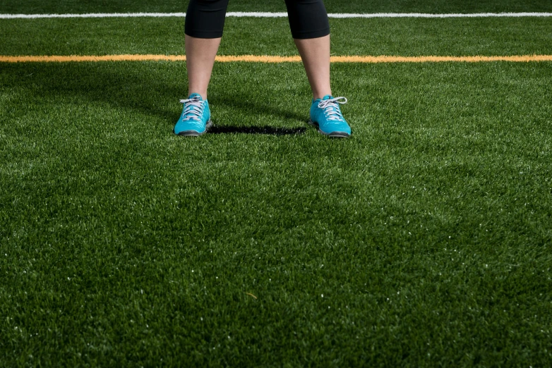 a person standing on grass holding a frisbee