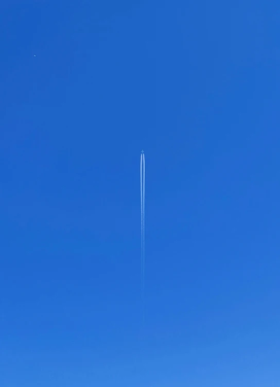 an airplane flies high in the air above the mountains