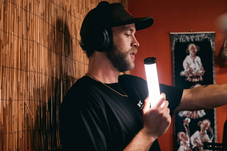 a person with headphones on holding a white light