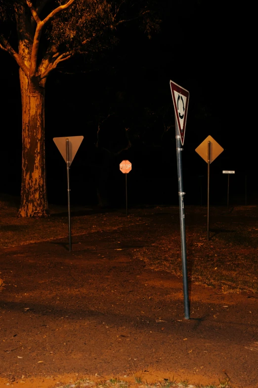 three different road signs on the side of the road