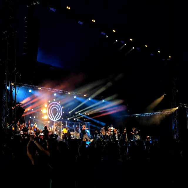 a crowd of people standing on top of a stage