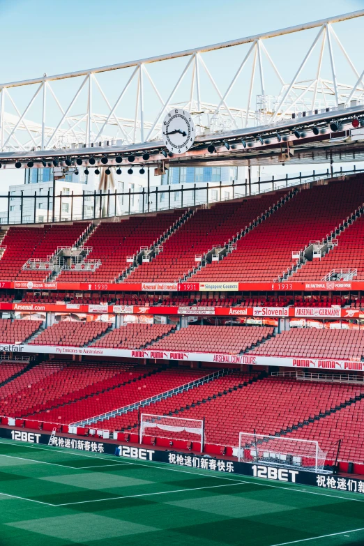 the interior of an empty stadium with a green field