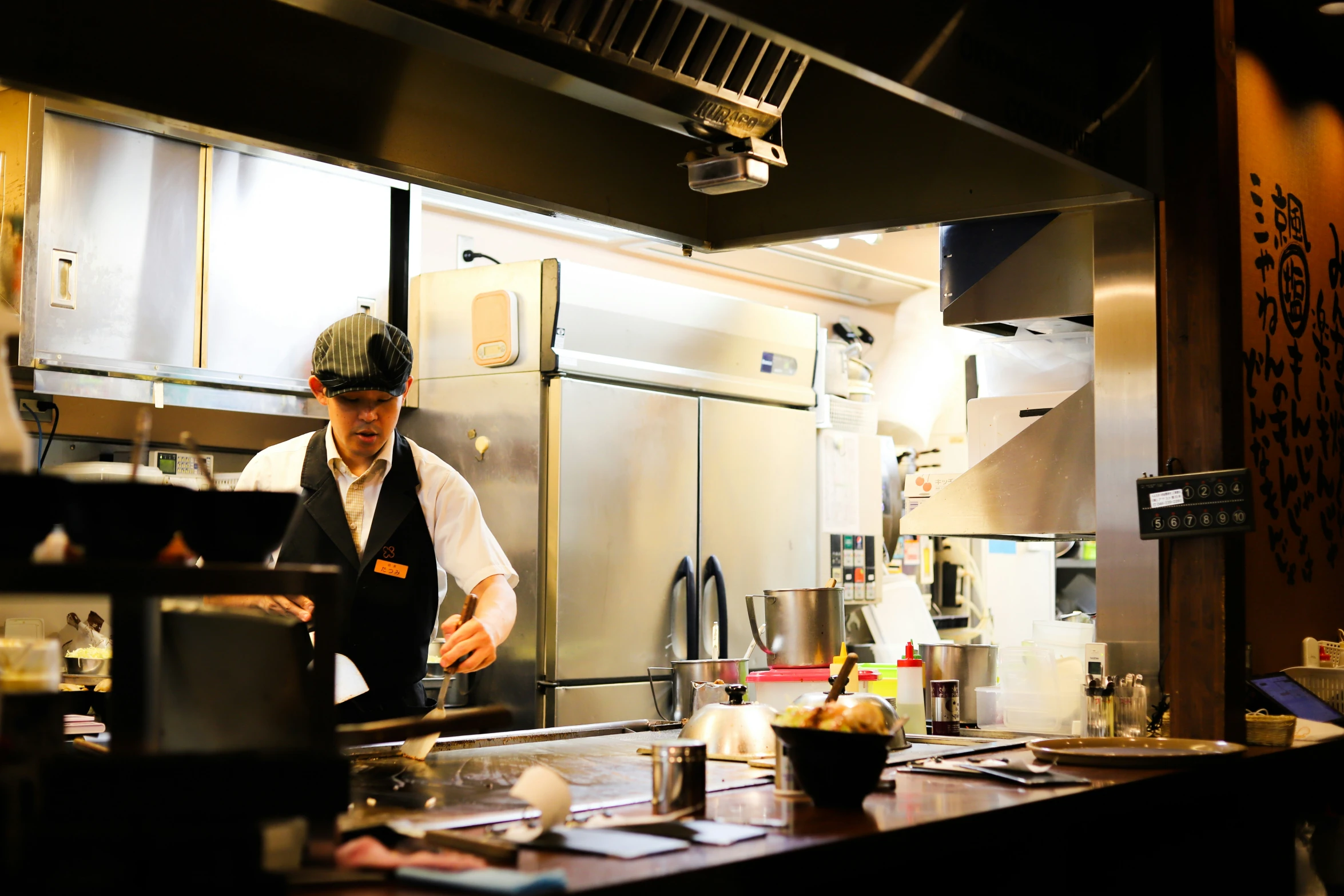 a man standing at the counter in a kitchen