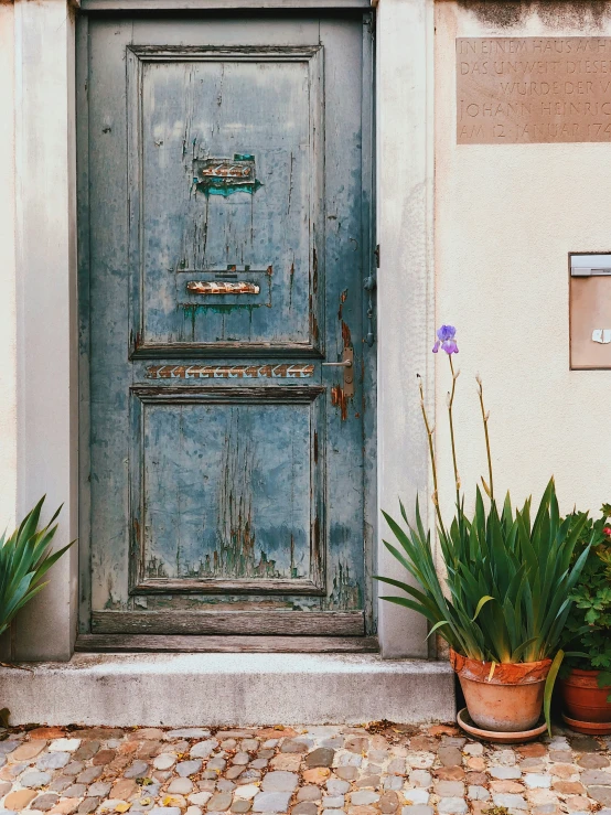 old blue wooden door in front of a house