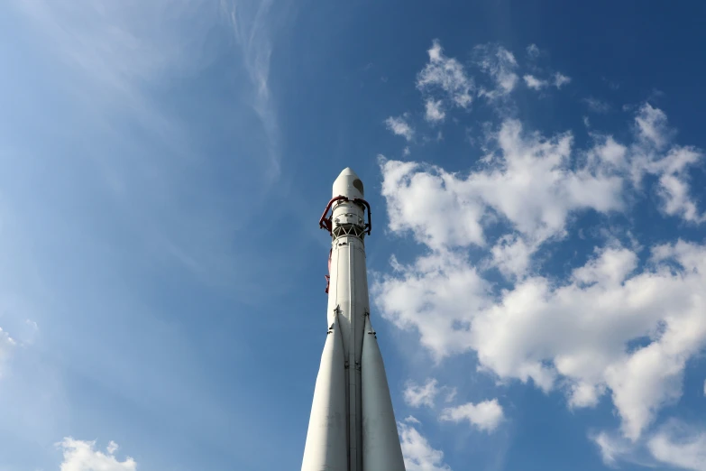 a tall white jet with a clock on it's side