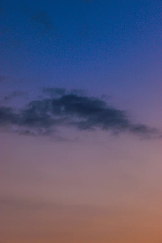 two airplanes are flying in the air during twilight