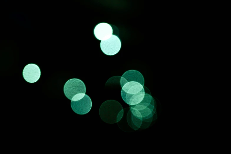 night view of a dark street with circles lights in it