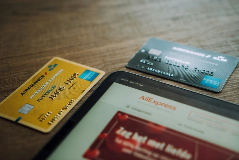 two credit cards and a tablet on a table