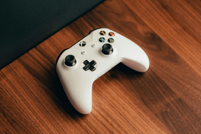 white gaming controller with two black ons on it