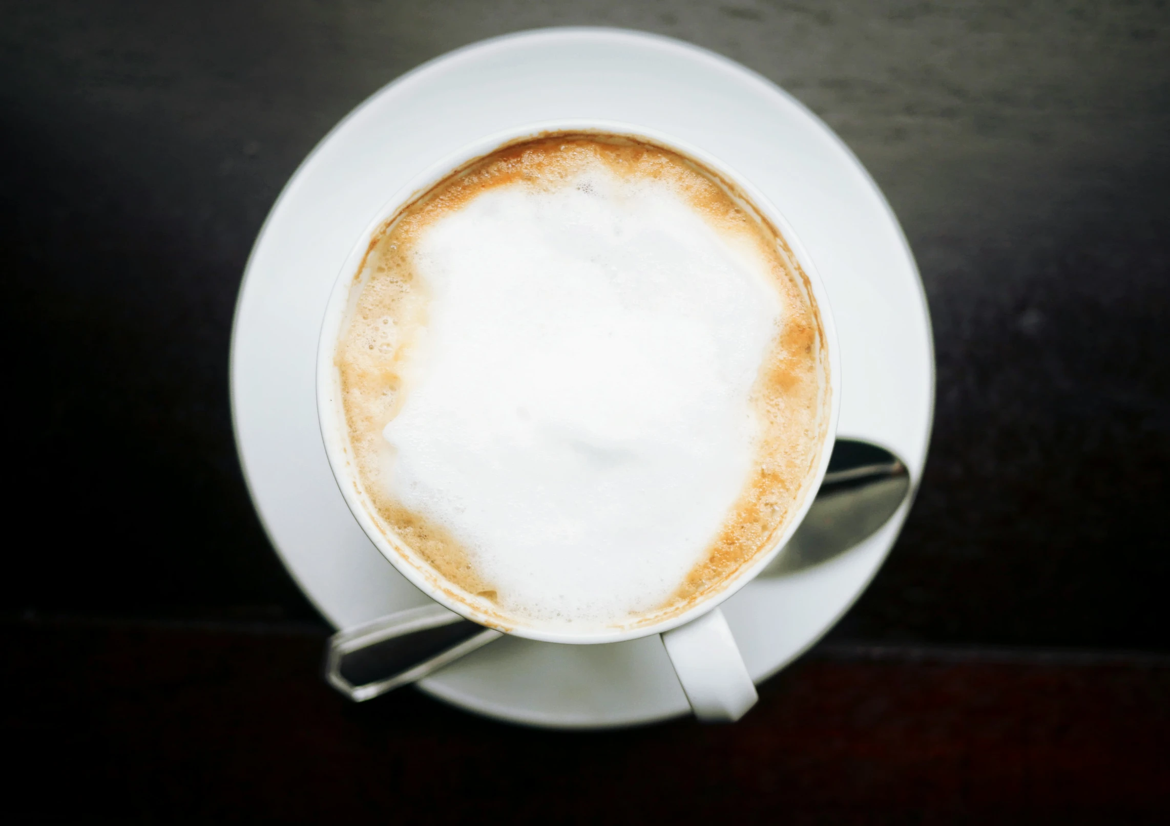 a cup of cappuccino sitting on top of a saucer