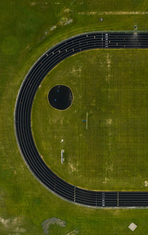 an overhead view of a track on a green lawn