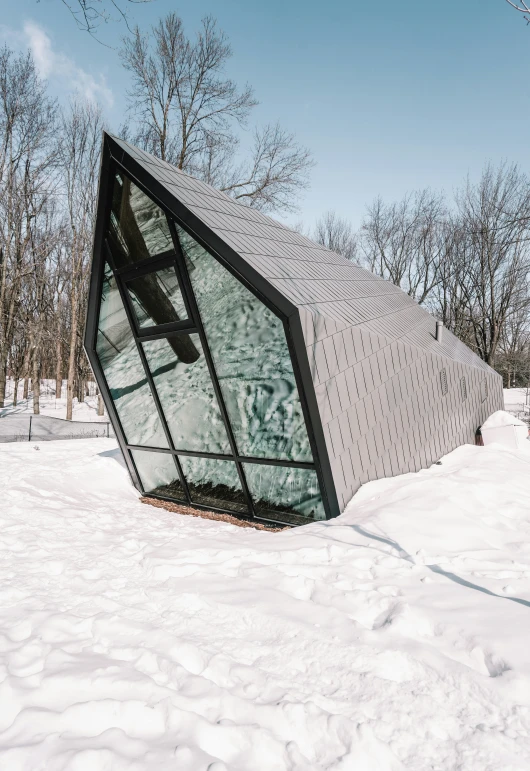 a broken building partially submerged in the snow