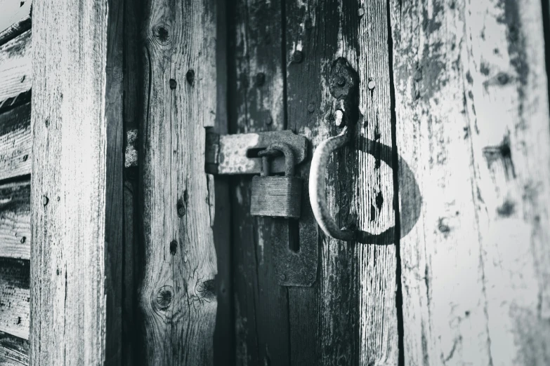 the latch on a door is on a wooden plank