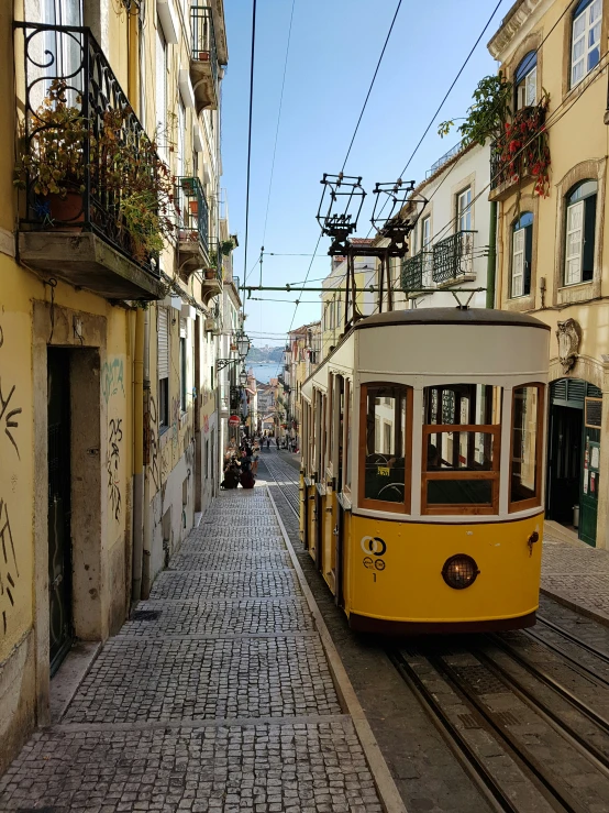 a city trolley driving through an old european street