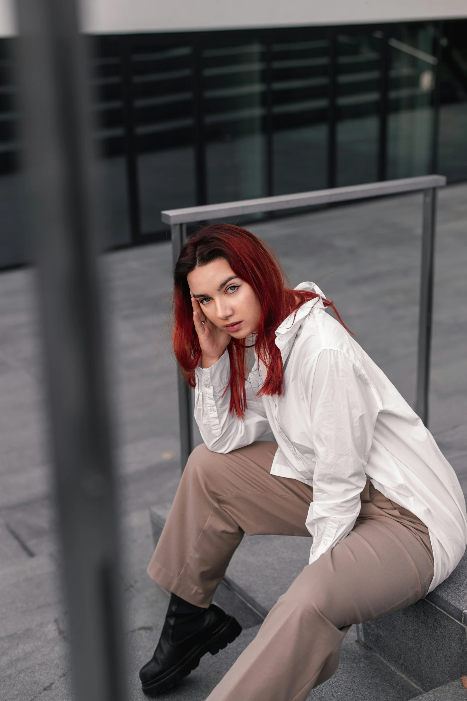 a woman is sitting on the stairs outside