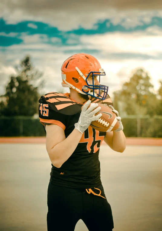 a man in a football uniform holding a football