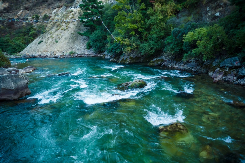 a view of water rushing through a rocky landscape