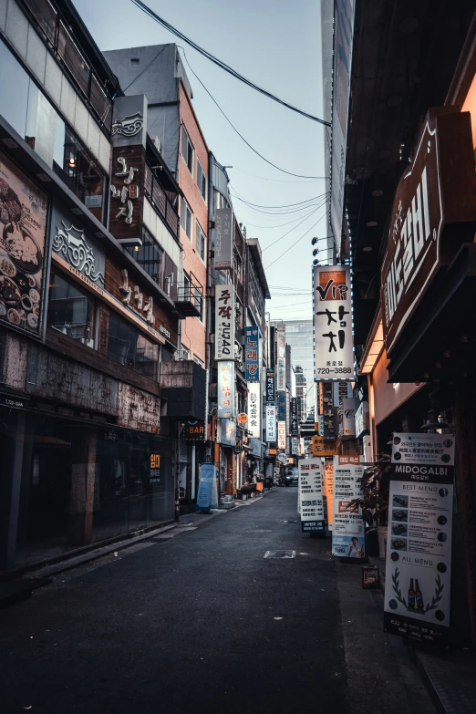 an empty street with sign boards everywhere around