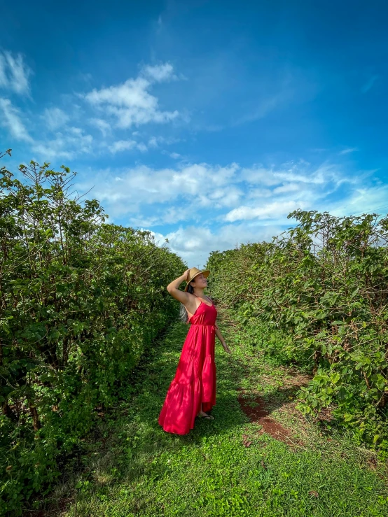 a woman walking on top of a green field