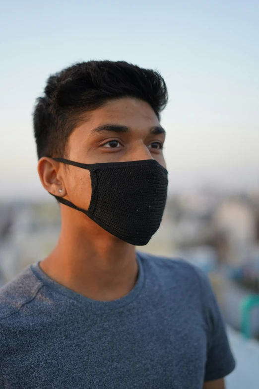a boy wearing a face mask and looking at the camera