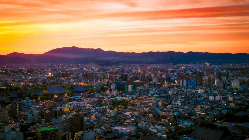 a city with hills and buildings in the background