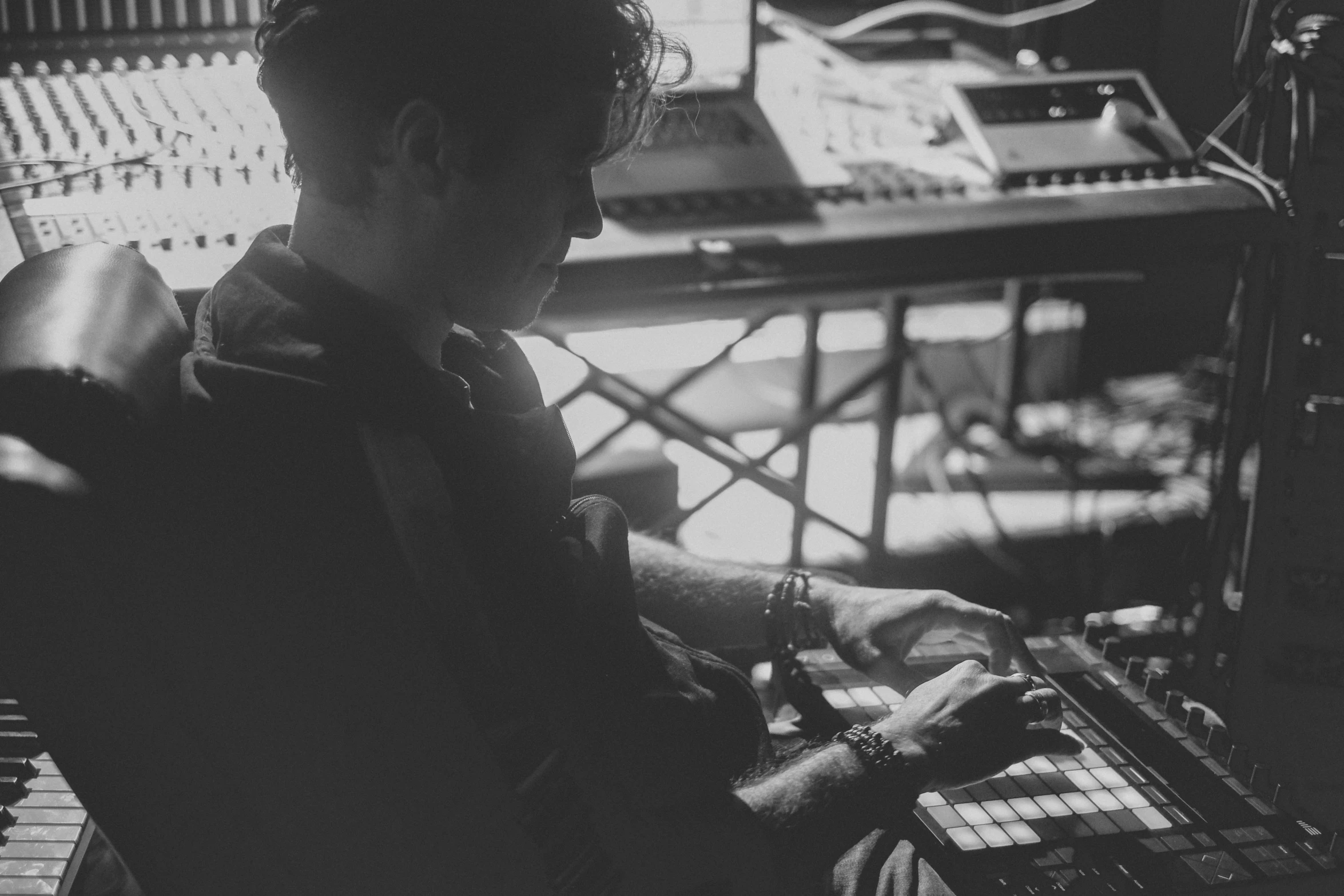 black and white po of a man working at a mixing desk