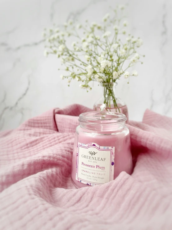 a pink jar holds some baby's breath flowers