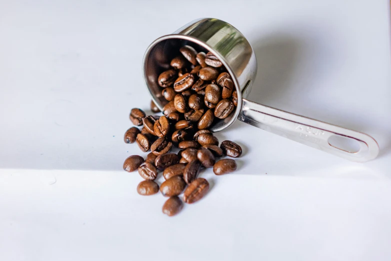 a bunch of nuts coming out of a coffee can