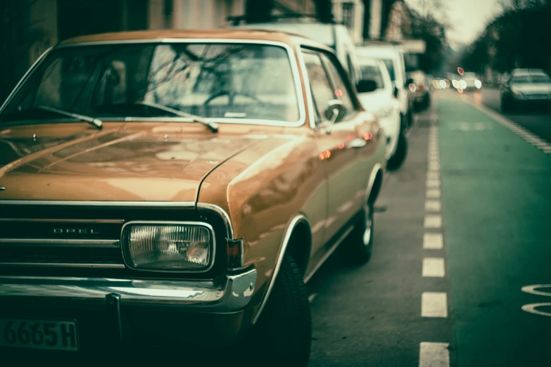 a yellow car is sitting parked in the street