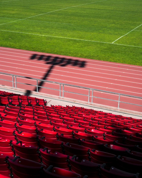 an empty stadium with red seats and no people sitting