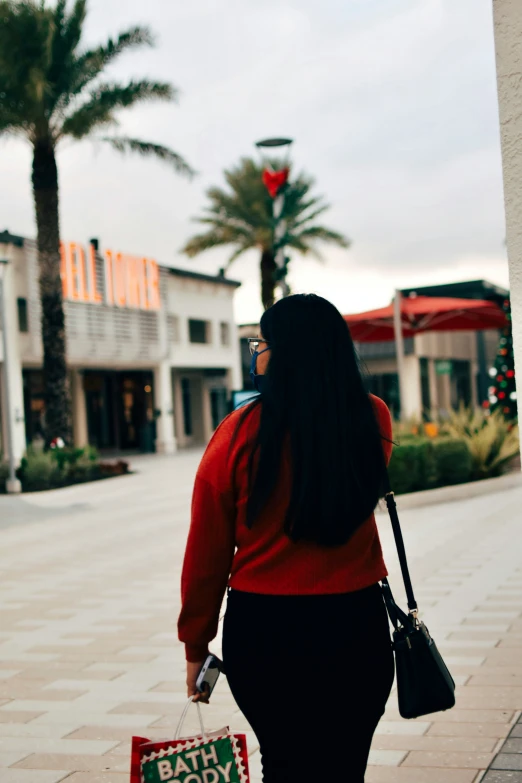 woman holding a baby bag and shopping on a mall