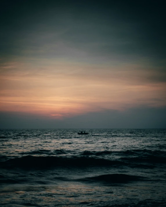 the water is dark and very calm at sunrise