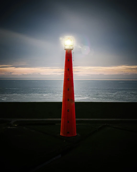 a traffic cone sitting next to the ocean