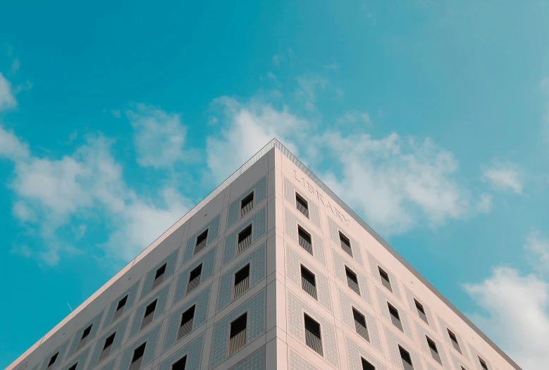 an upward view of a pink building on a clear day