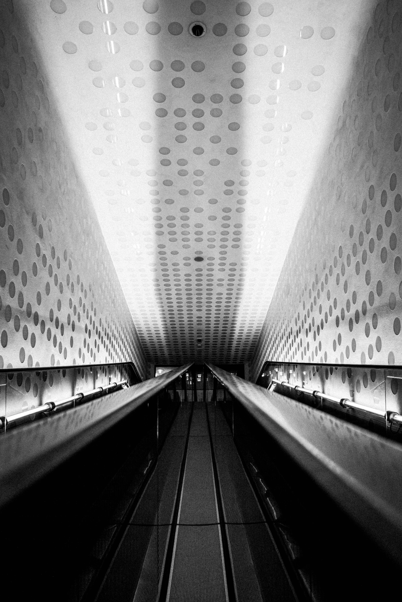 two people standing in an empty subway station