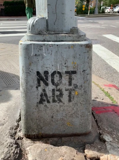 a white fire hydrant on the sidewalk with a sign reading not air