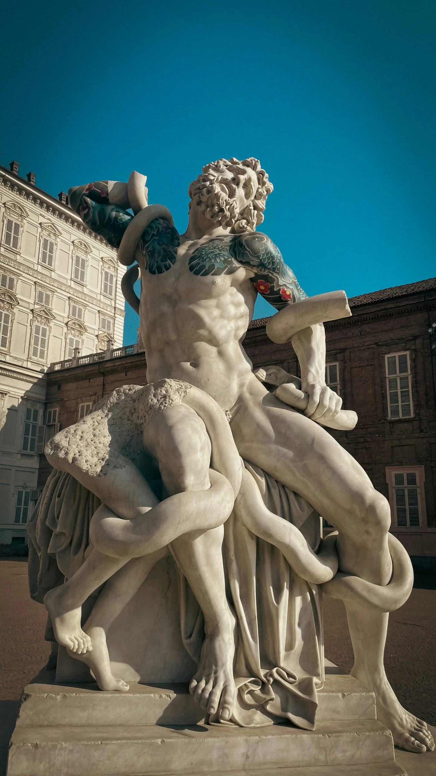 the statue of a male figure holding an umbrella