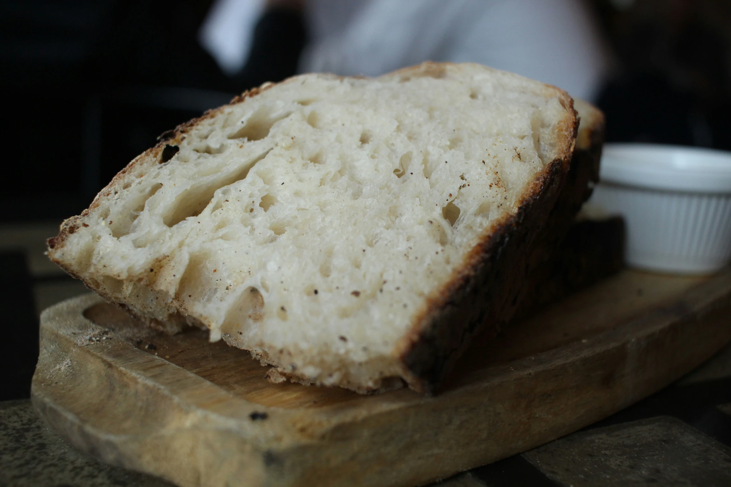 a loaf of bread sitting on top of a wooden  board