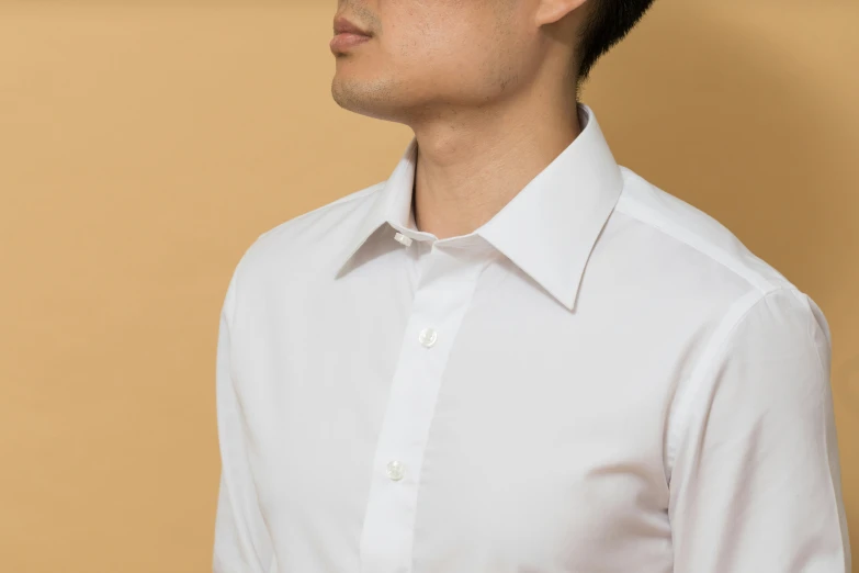 a man wearing white is looking off to the side