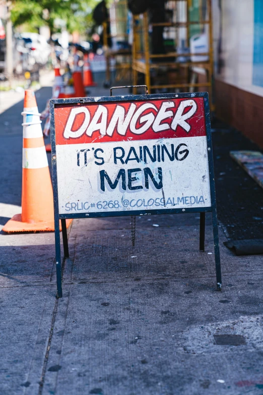 a sign is propped up on a side walk